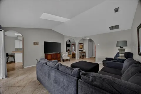 a living room with furniture and a view of en suite bathroom