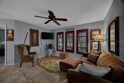 a living room with furniture ceiling fan and a window
