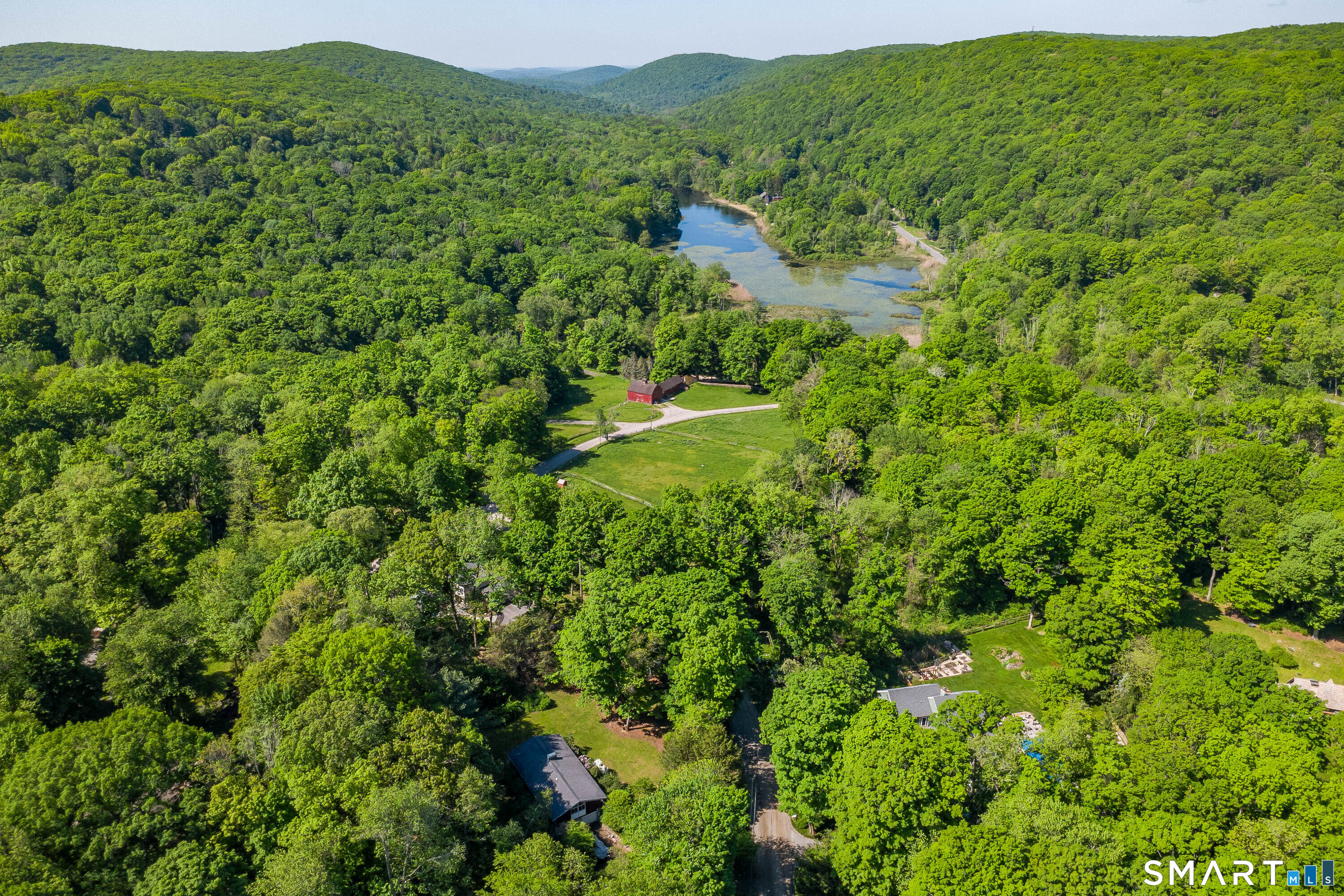 4 Pepper Pond Road Sherman, CT 06784 - Photo 29 of 33 a view of a lush green forest with trees and some houses