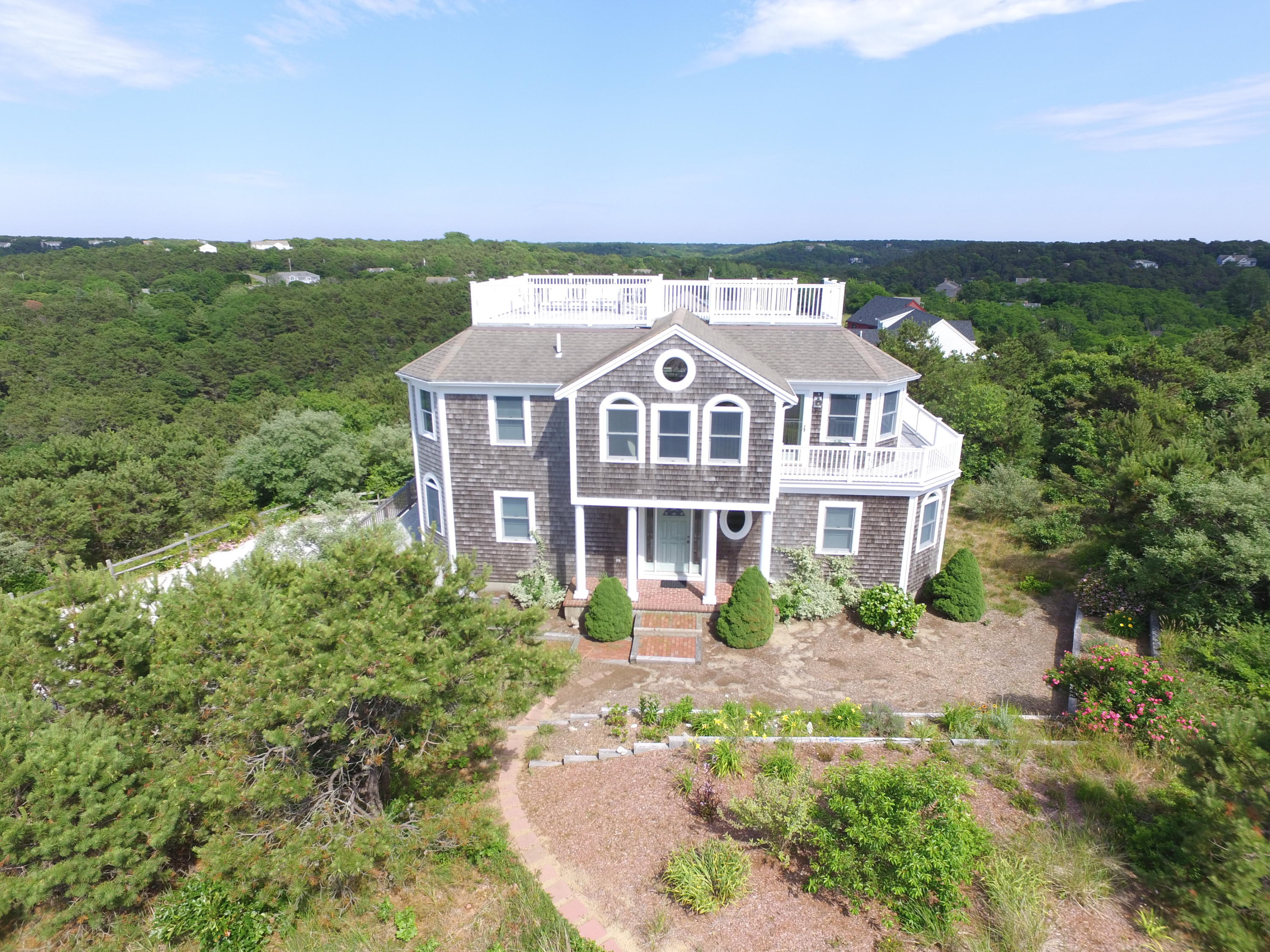 4 High Ridge Rd Extension Truro, MA 02666 - Photo 4 of 46 a front view of a house with a garden