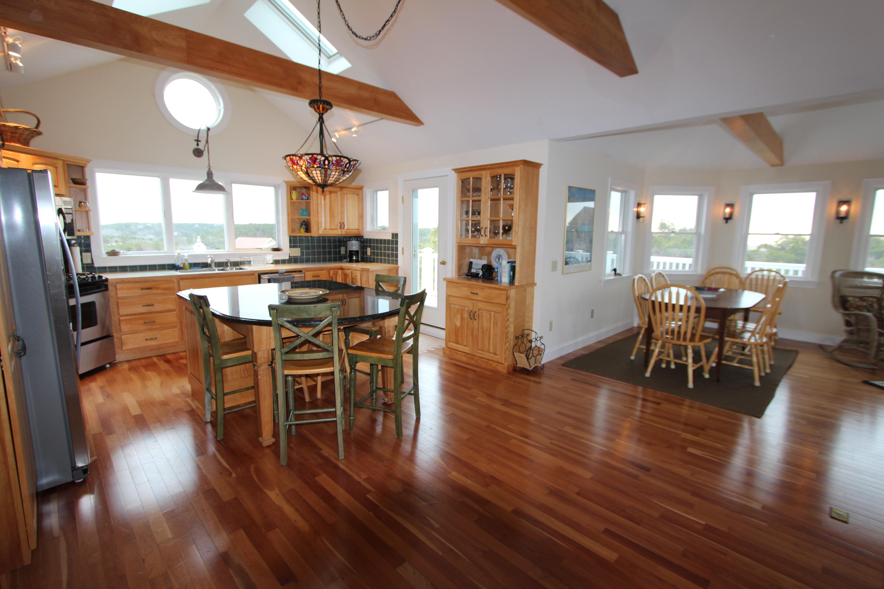 4 High Ridge Rd Extension Truro, MA 02666 - Photo 7 of 46 a dining room with furniture a chandelier and wooden floor