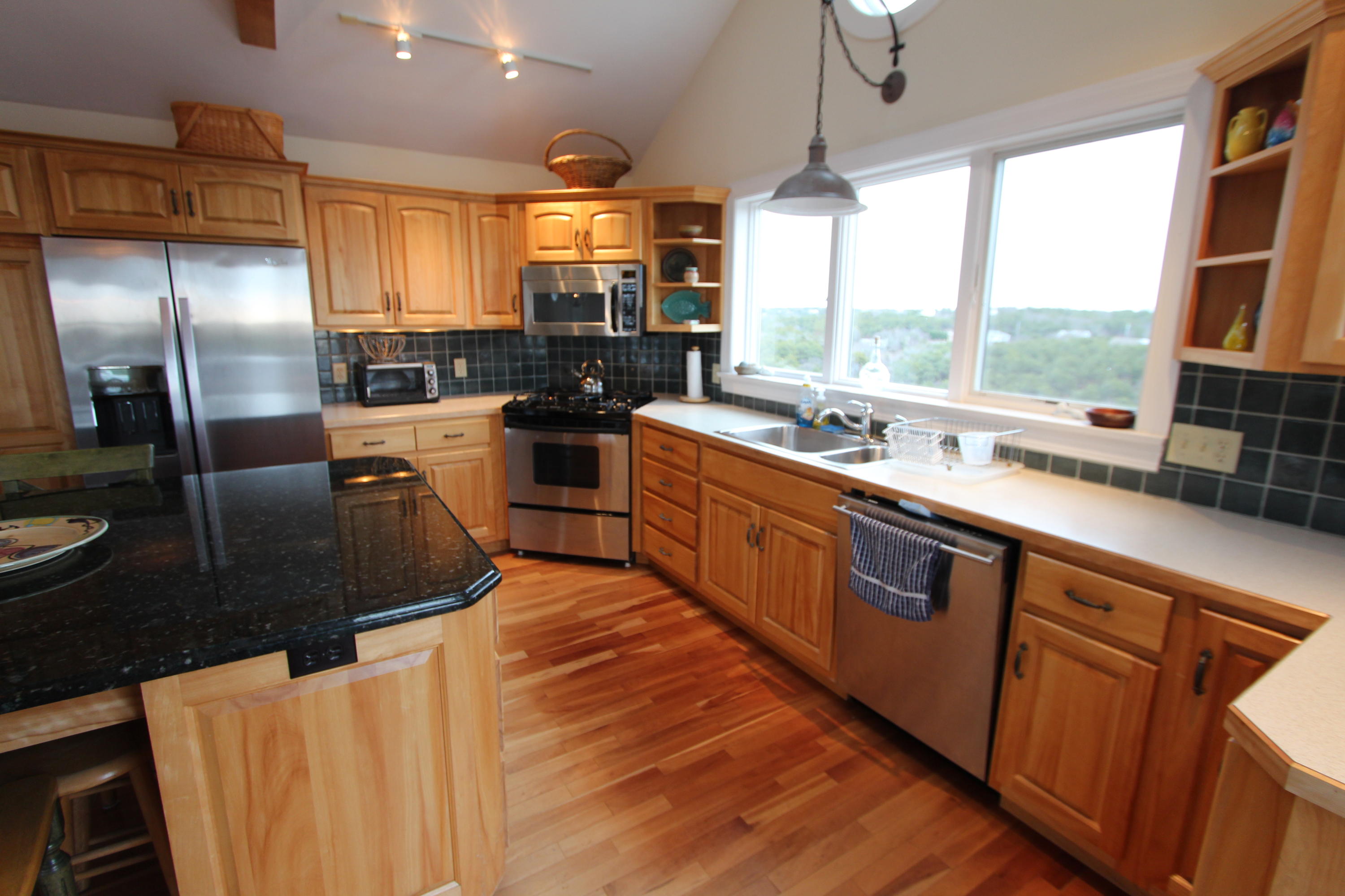 4 High Ridge Rd Extension Truro, MA 02666 - Photo 9 of 46 a kitchen with stainless steel appliances granite countertop a sink a stove and a refrigerator