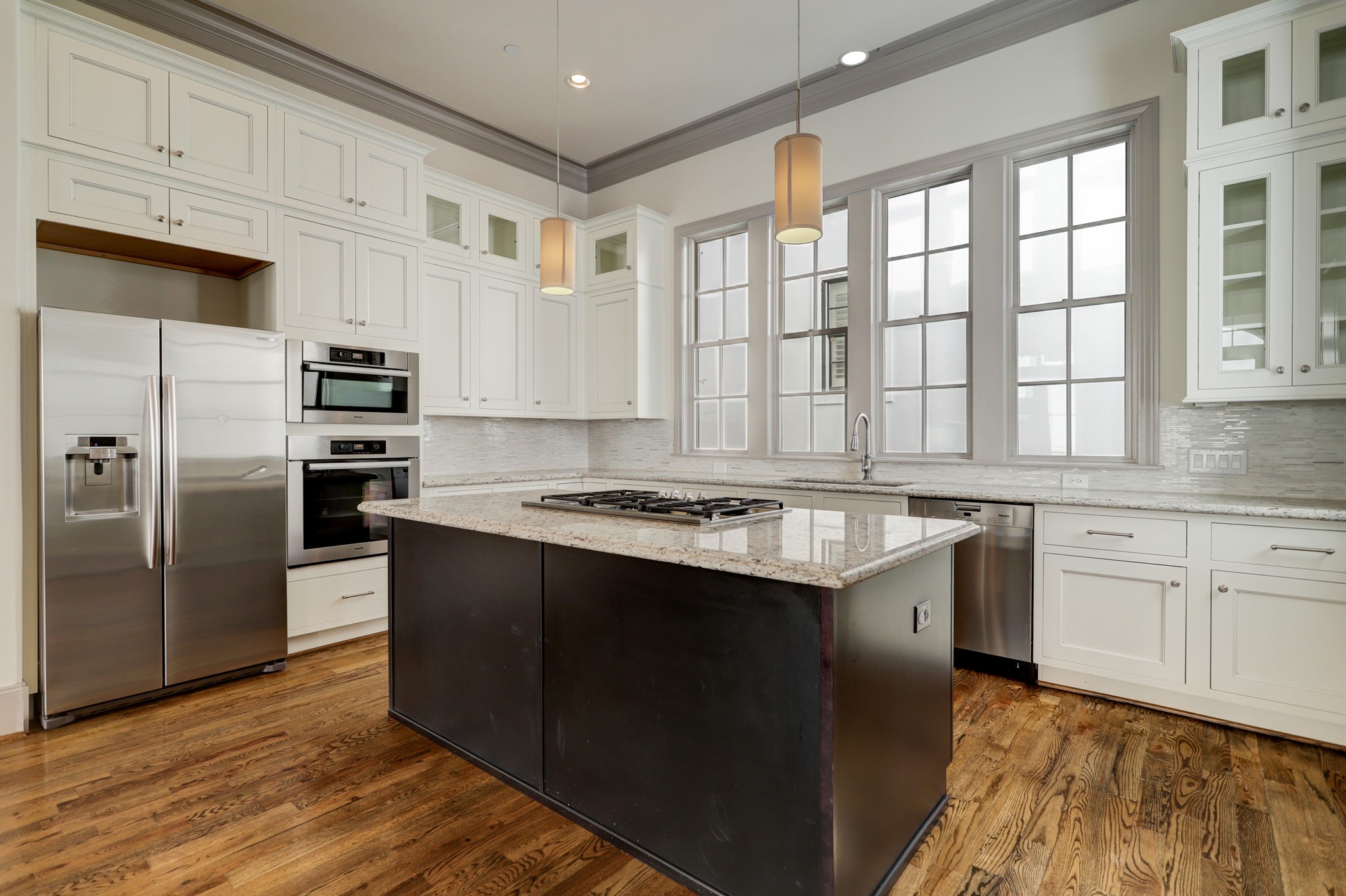 4838 Austin Street Houston, TX 77004 - Photo 12 of 27 a kitchen with stainless steel appliances granite countertop a stove a sink and a refrigerator