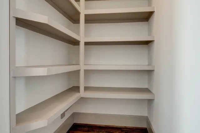 a view of walk in closet with empty racks