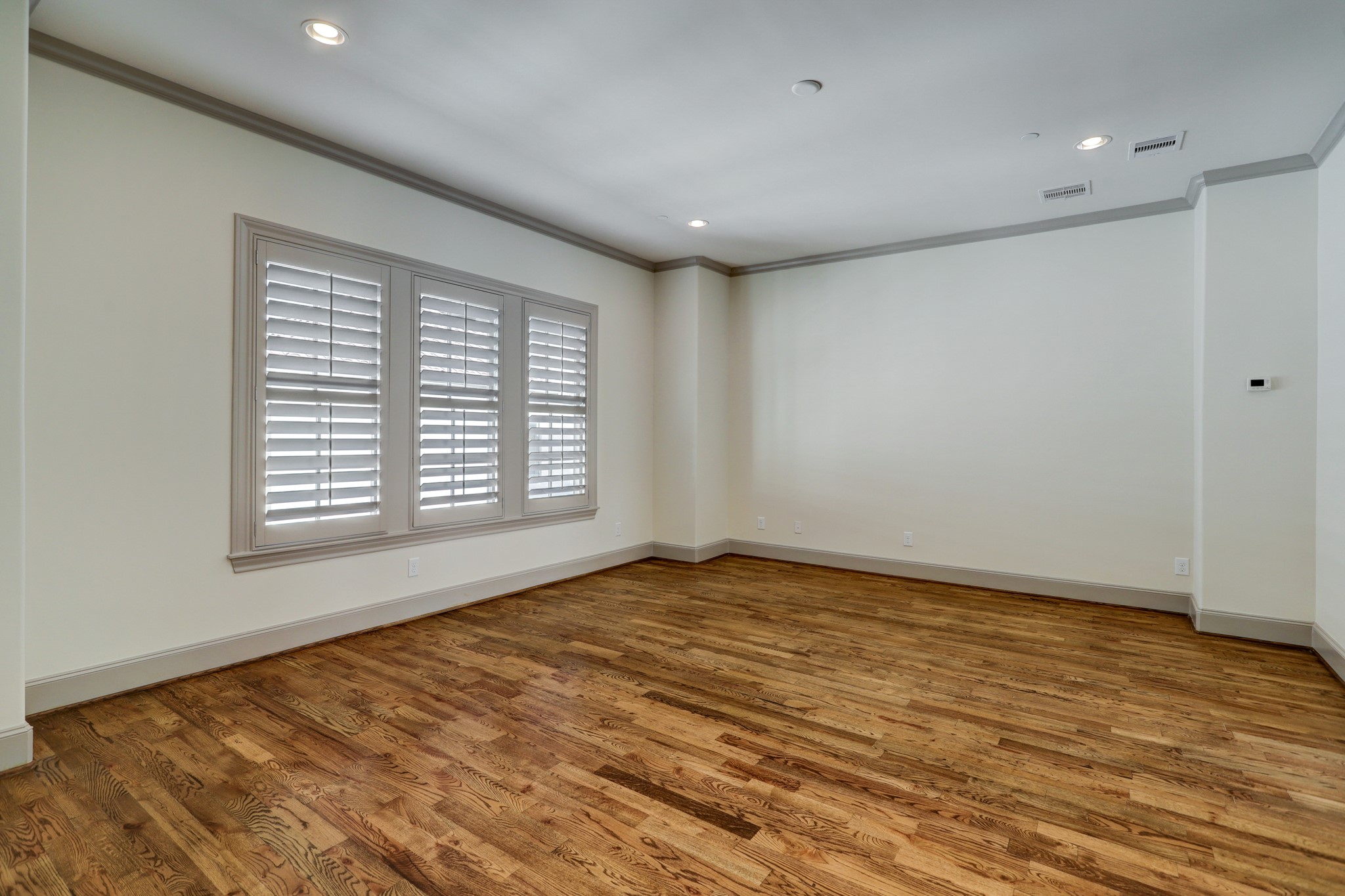 4838 Austin Street Houston, TX 77004 - Photo 15 of 27 a view of an empty room with wooden floor and a window