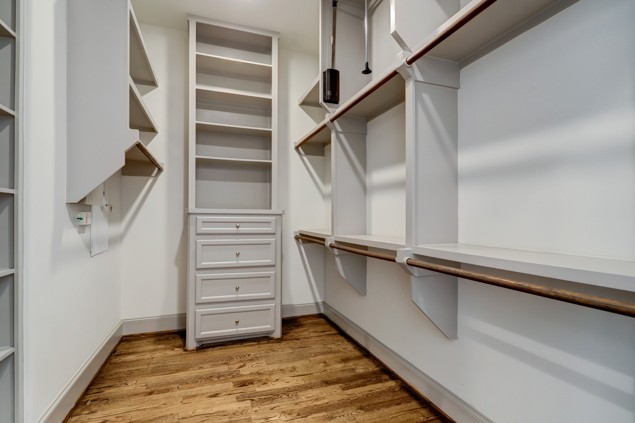 4838 Austin Street Houston, TX 77004 - Photo 19 of 27 a view of walk in closet with empty racks