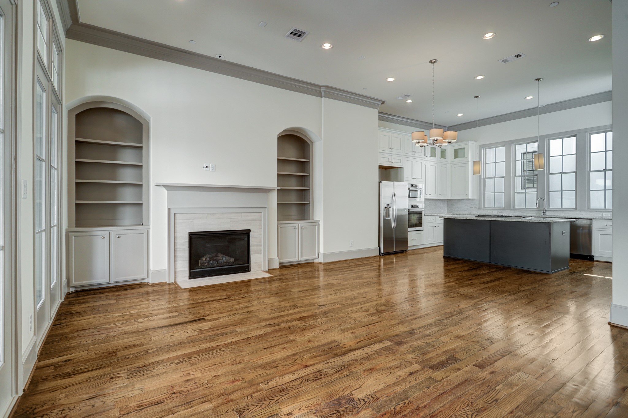 4838 Austin Street Houston, TX 77004 - Photo 9 of 27 a view of empty room with wooden floor and fireplace