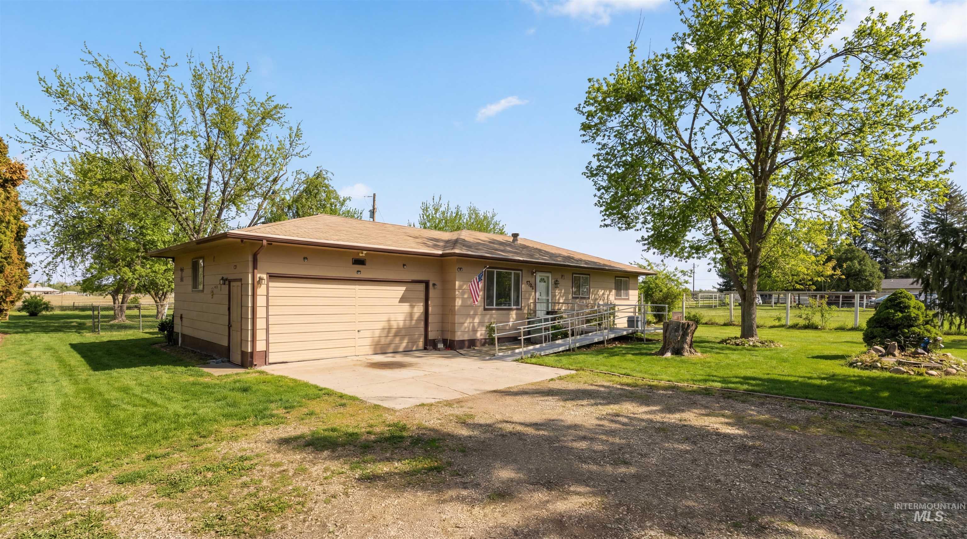 19076 Pleasant Avenue Caldwell, ID 83607 - Photo 1 of 37 Back of property featuring driveway, a garage, and a patio area