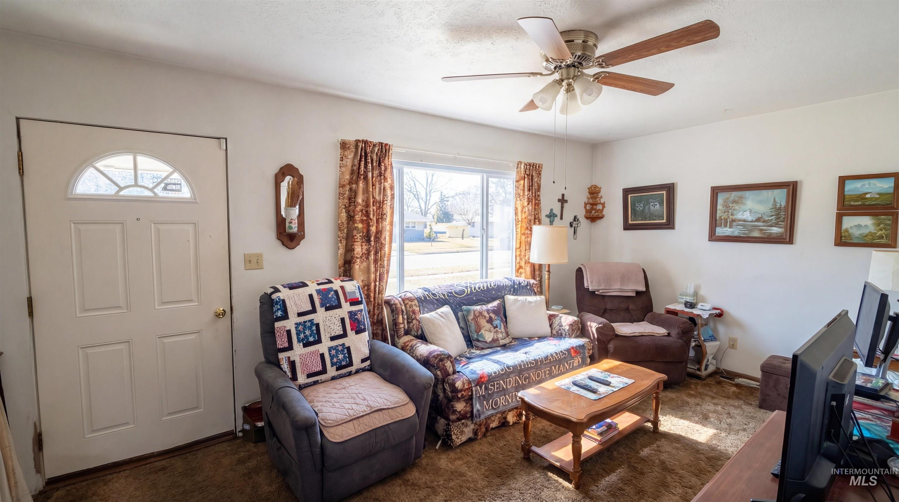 19076 Pleasant Avenue Caldwell, ID 83607 - Photo 11 of 37 Living area featuring carpet floors and ceiling fan
