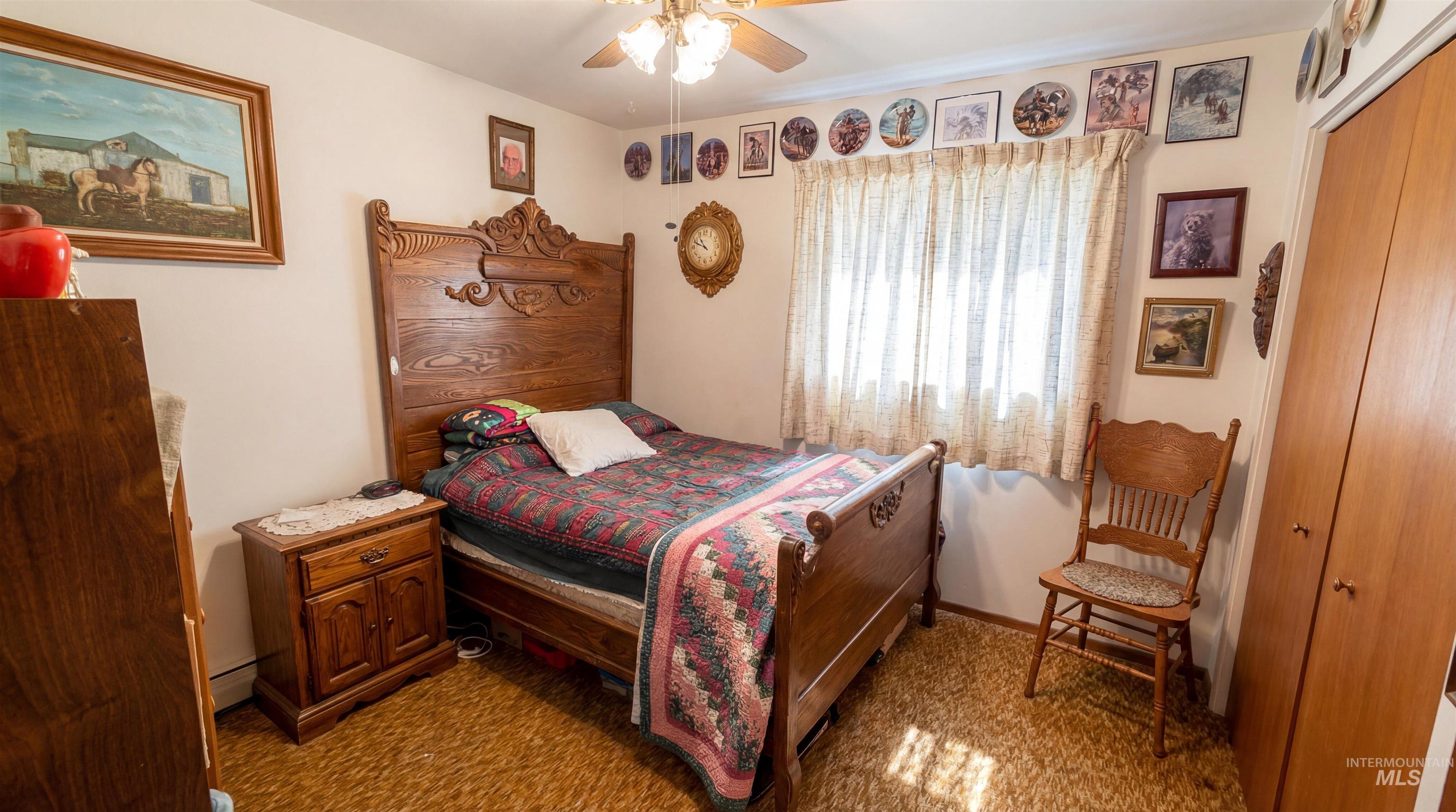 19076 Pleasant Avenue Caldwell, ID 83607 - Photo 15 of 37 Bedroom with ceiling fan, light carpet, and a baseboard radiator