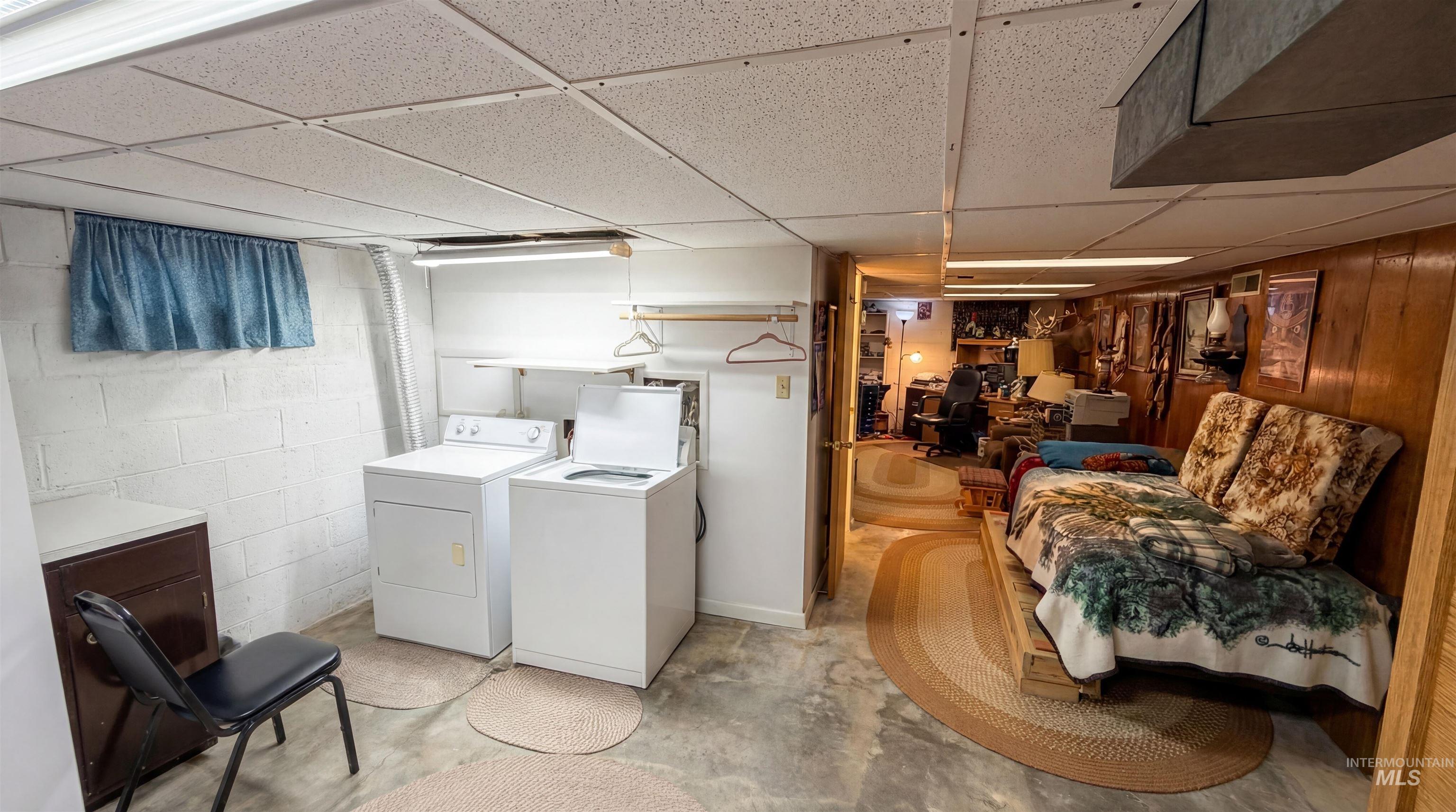 19076 Pleasant Avenue Caldwell, ID 83607 - Photo 23 of 37 Laundry room with a drop ceiling, a desk, washer and dryer, and concrete flooring