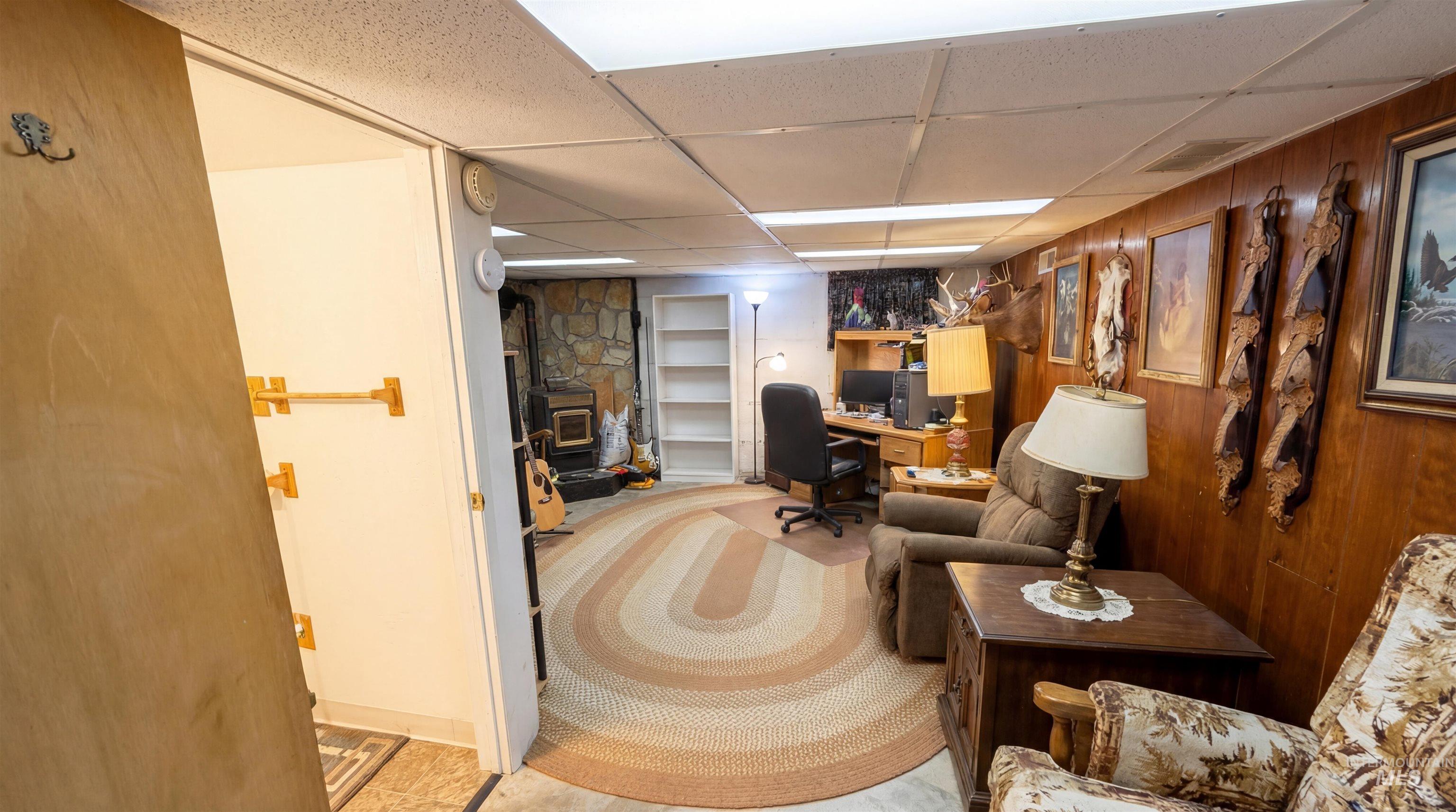 19076 Pleasant Avenue Caldwell, ID 83607 - Photo 24 of 37 Office space with a drop ceiling, carpet, built in features, and wooden walls