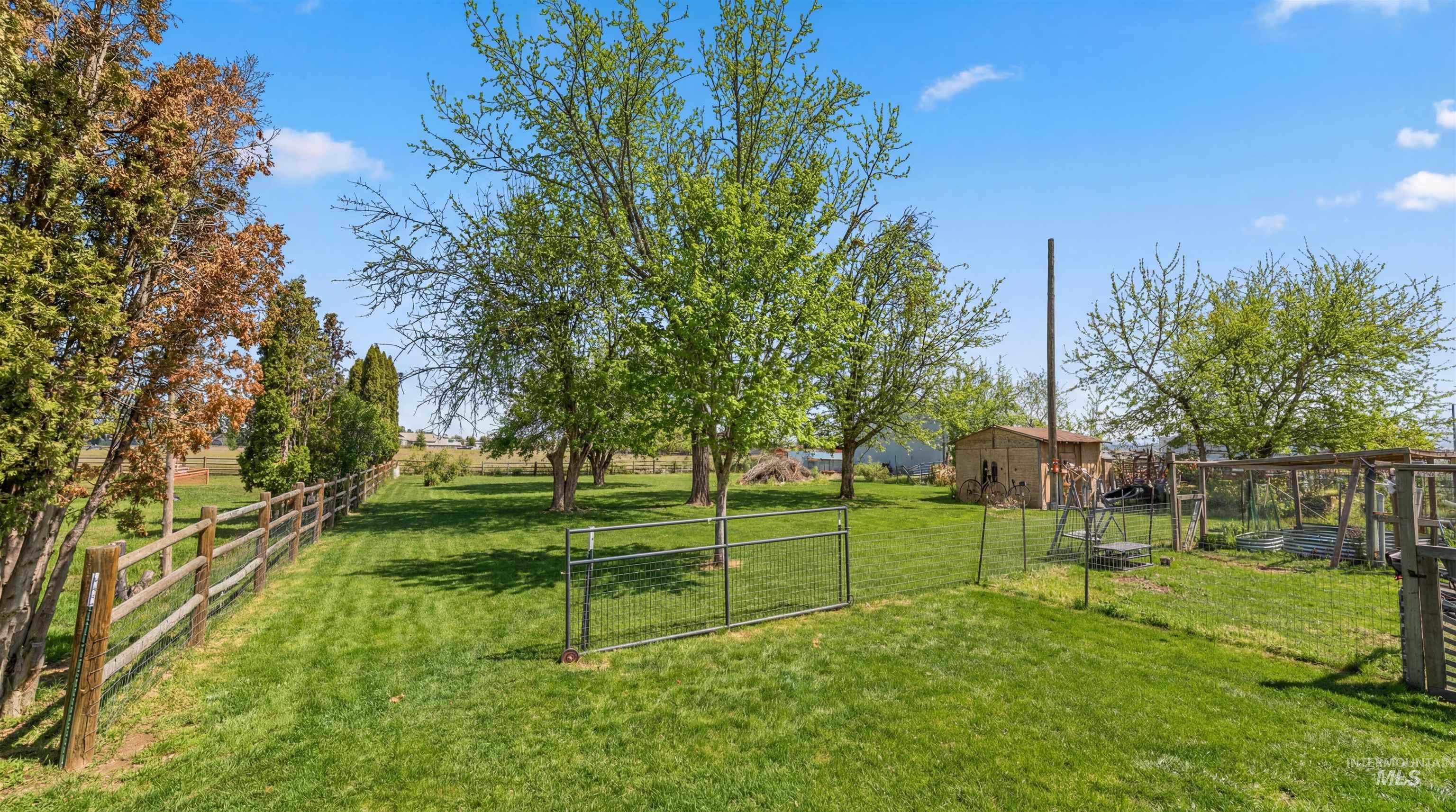 19076 Pleasant Avenue Caldwell, ID 83607 - Photo 29 of 37 View of yard with a gate and an outdoor structure