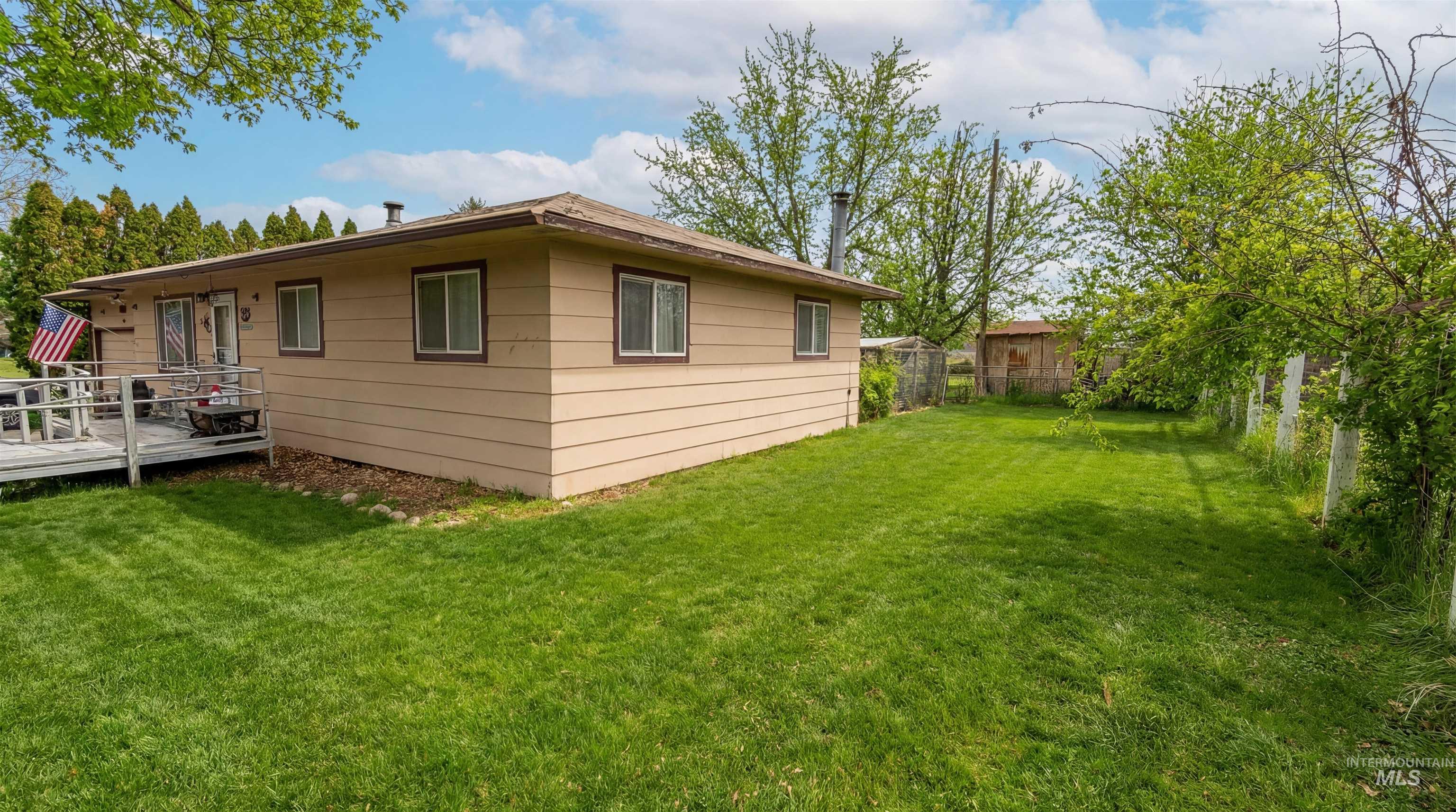 19076 Pleasant Avenue Caldwell, ID 83607 - Photo 33 of 37 View of side of property with a wooden deck