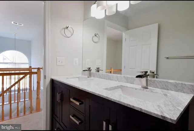 a bathroom with a sink double vanity and a mirror