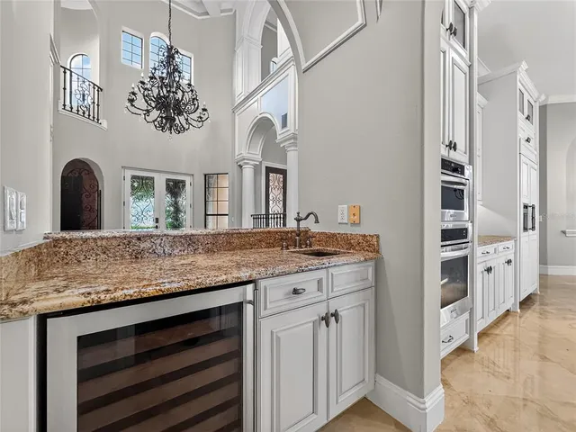 a bathroom with a granite countertop double vanity sink and a mirror