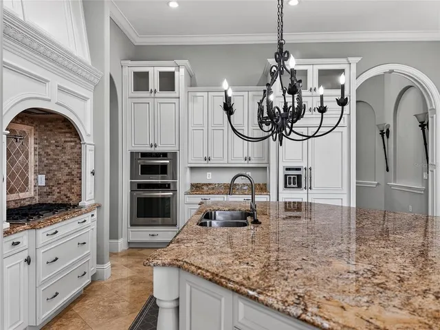 a kitchen with stainless steel appliances granite countertop a stove and cabinets