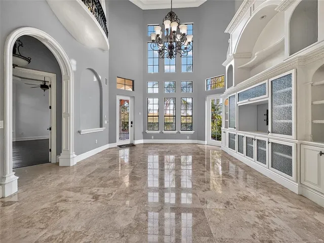 a view of an empty room with chandelier
