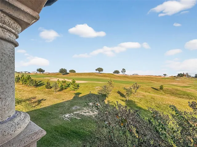 a front view of a house with a lots of windows and plants