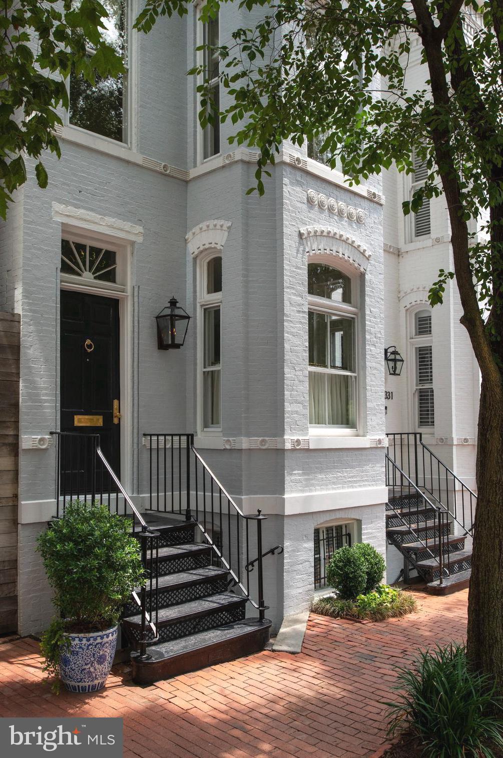 a view of a house with a small yard and plants
