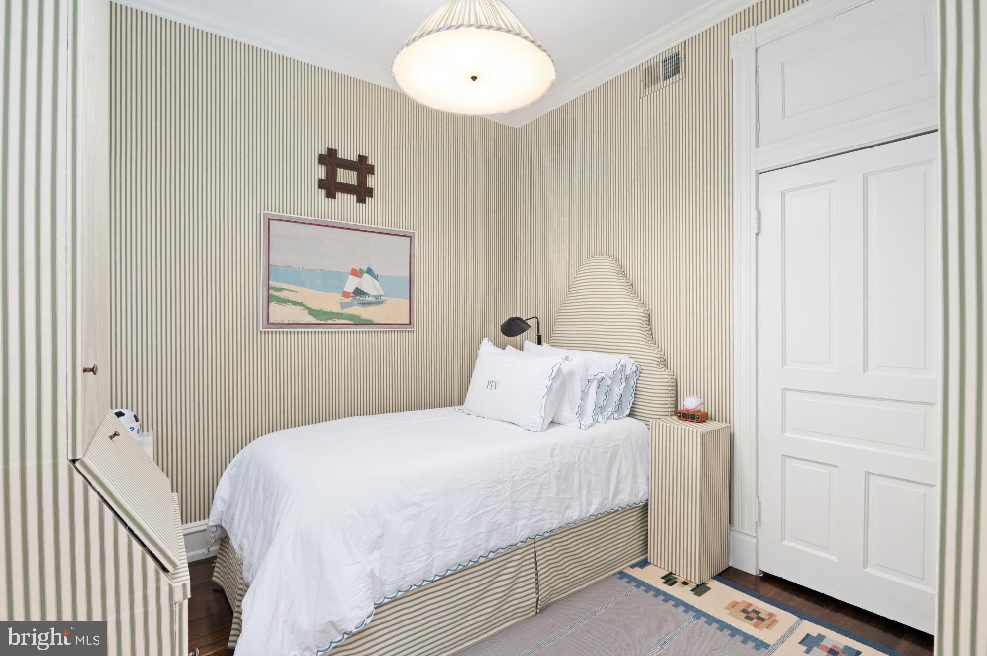 1333 30th Street Northwest Washington, DC 20007 - Photo 17 of 26 a bedroom with a bed and a painting on the wall