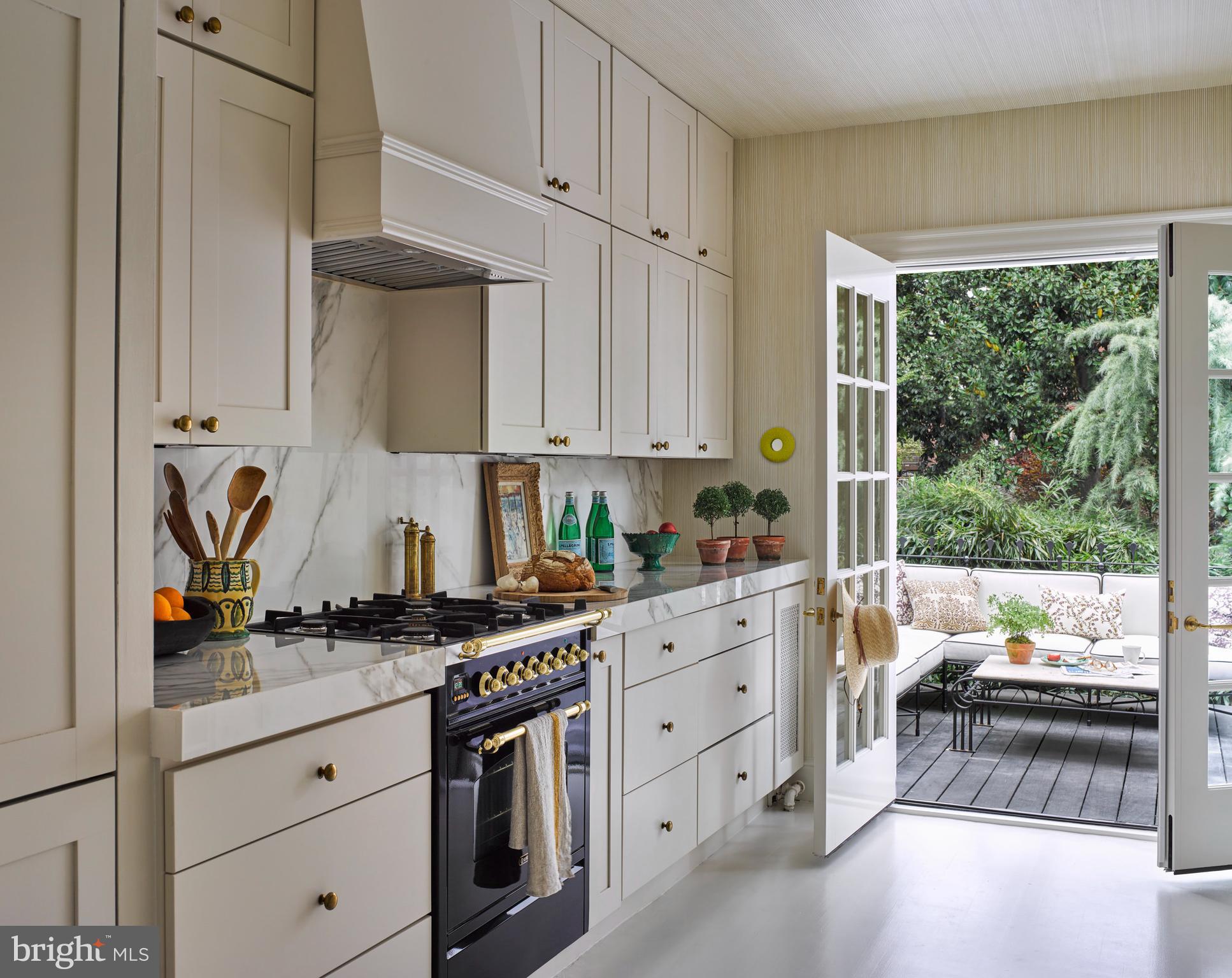 1333 30th Street Northwest Washington, DC 20007 - Photo 8 of 26 a kitchen with stainless steel appliances a stove a sink and a white cabinets