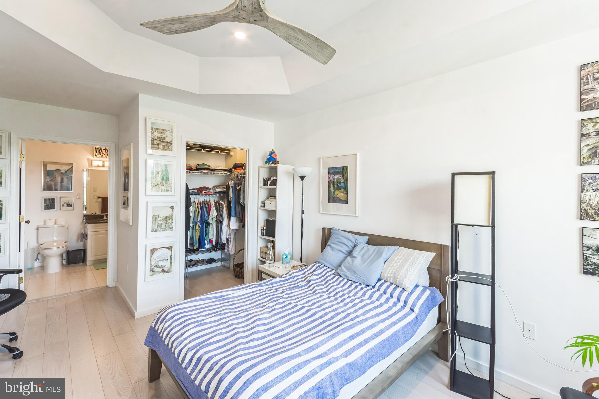 2402 Windrow Drive Princeton, NJ 08540 - Photo 13 of 19 a bedroom with a large bed and a chandelier