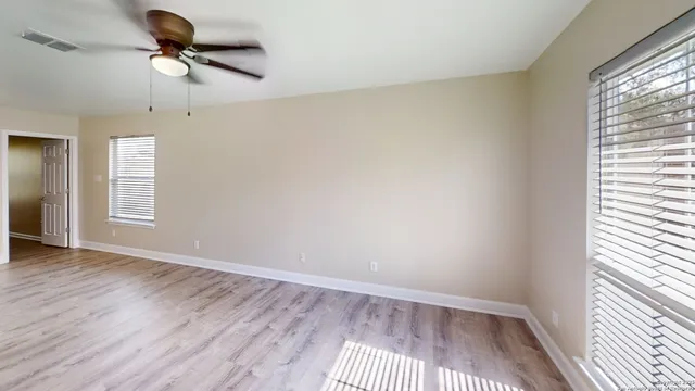 wooden floor in an empty room with a window
