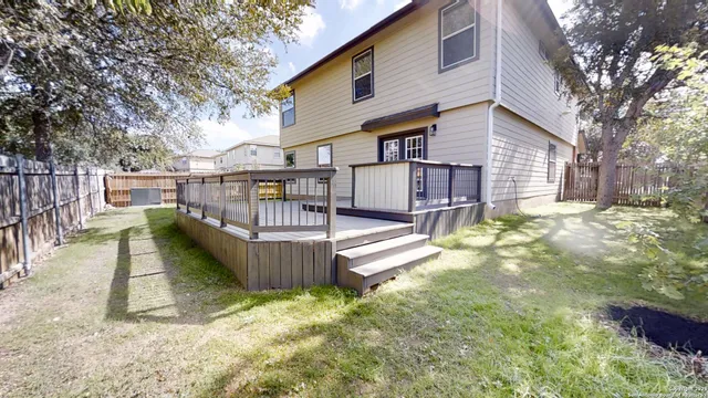 a view of a house with wooden floor roof and covered with tall trees
