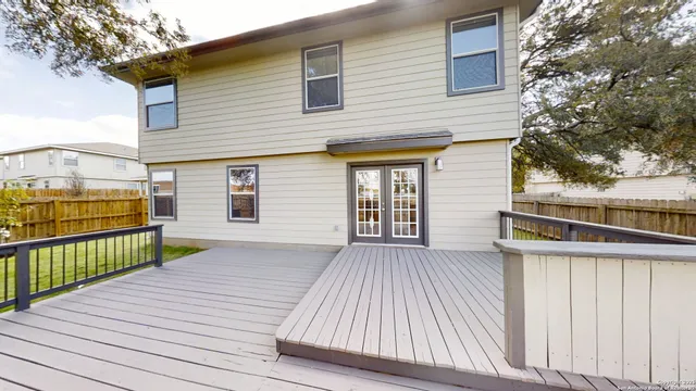 a view of a house with a wooden deck