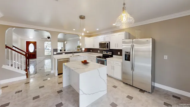 a kitchen with refrigerator and cabinets