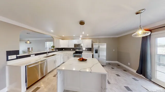 a kitchen with a sink a stove and cabinets