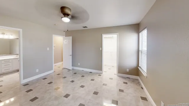 a view of a big room with windows and cabinet