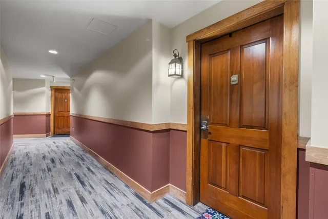 a view of a house with a yard and potted plants