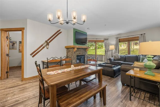 a living room with furniture a fireplace and a chandelier