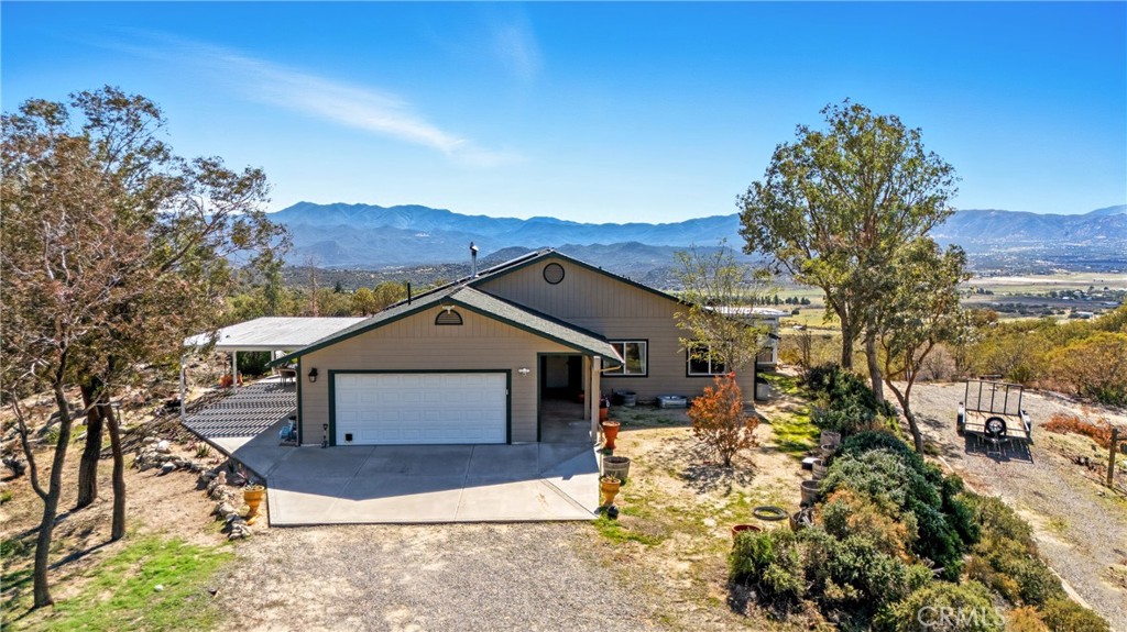 61455 Indian Paint Brush Road Anza, CA 92539 - Photo 1 of 60 a front view of a house with a yard and garage