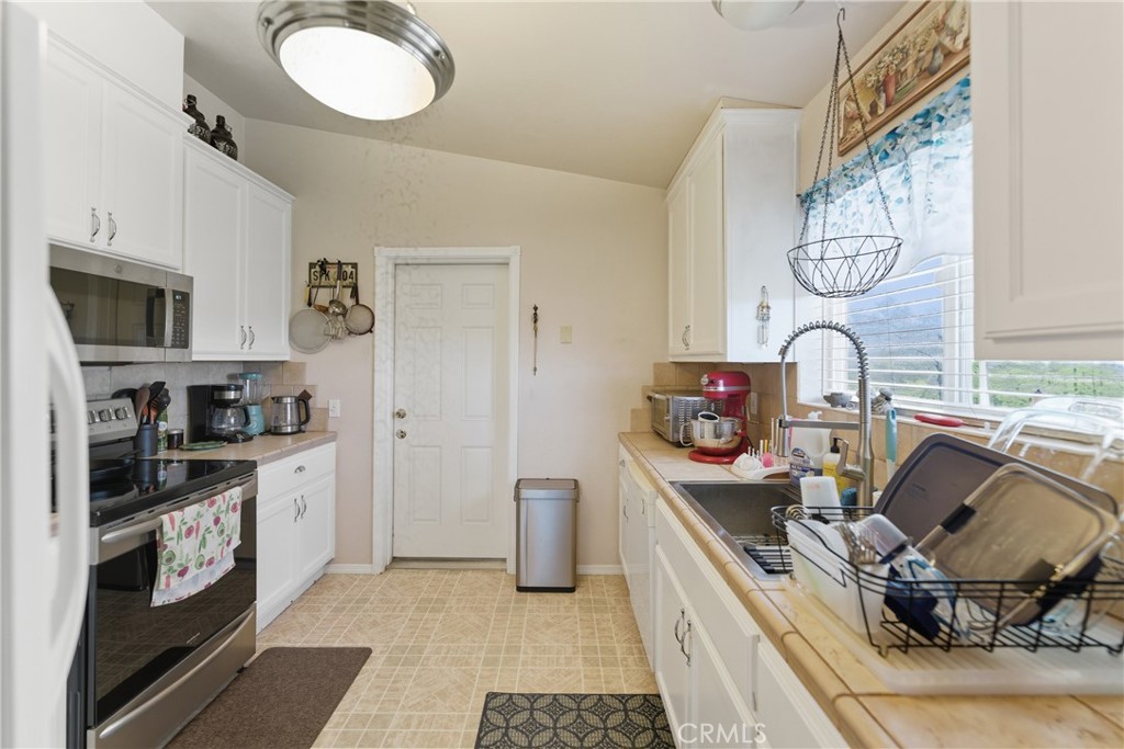 61455 Indian Paint Brush Road Anza, CA 92539 - Photo 11 of 60 a kitchen with stainless steel appliances granite countertop a sink and a stove