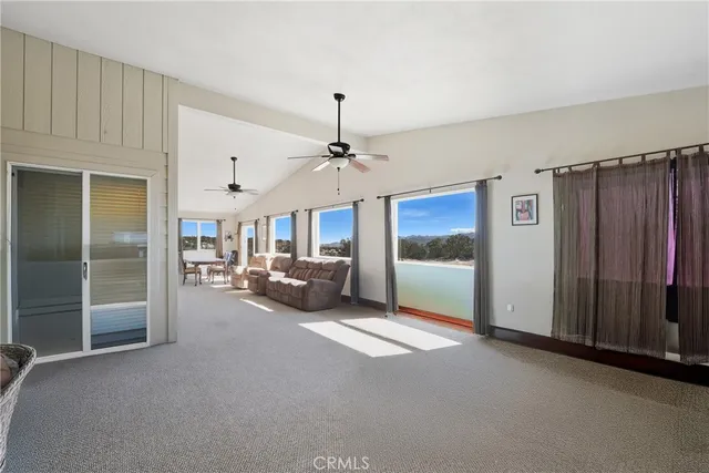 a view of a livingroom with furniture and a ceiling fan