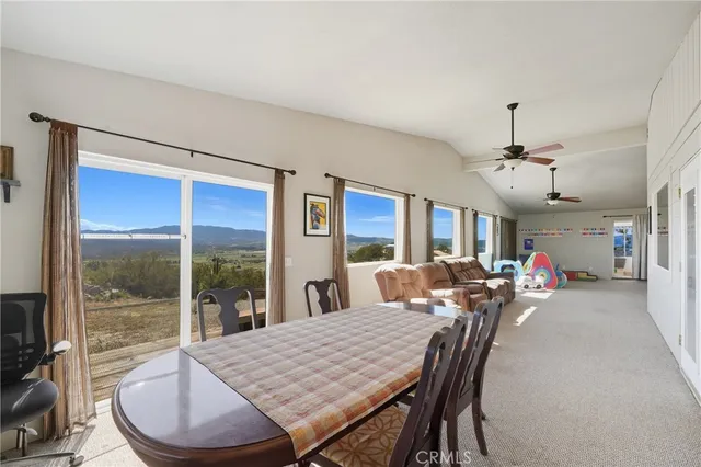 a view of a dining room with furniture wooden floor and chandelier