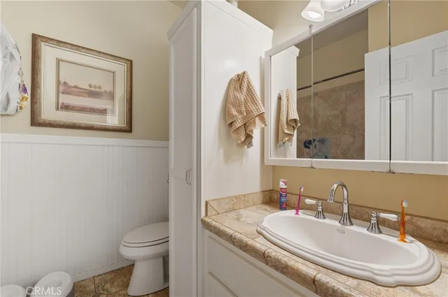 a bathroom with a sink vanity and a mirror