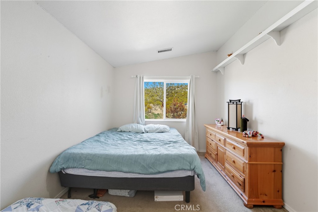 61455 Indian Paint Brush Road Anza, CA 92539 - Photo 25 of 60 a bedroom with a bed and wooden floor