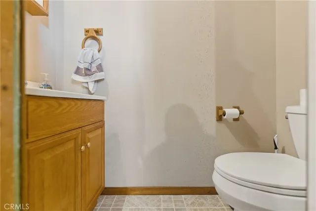 a view of a dry yard with mountain and trees