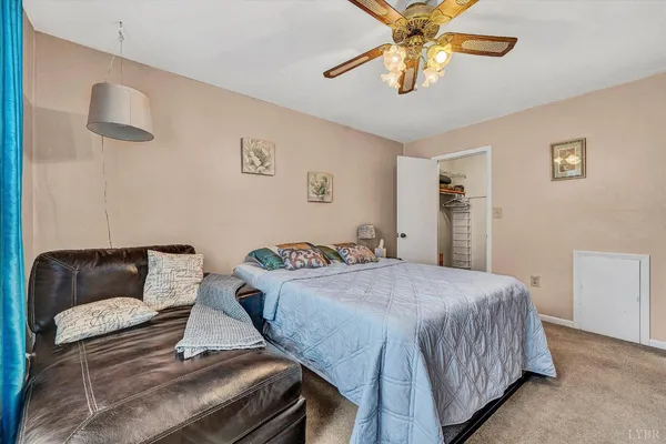 a bedroom with a bed and a couch