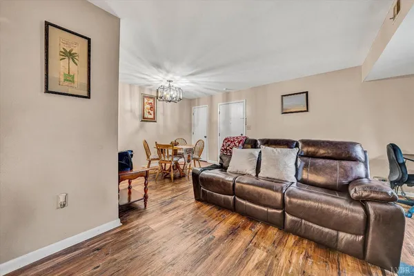 a living room with furniture and a chandelier