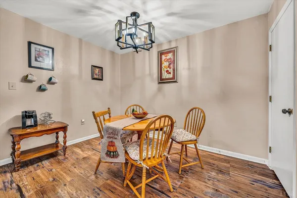 a dining room with furniture and wooden floor