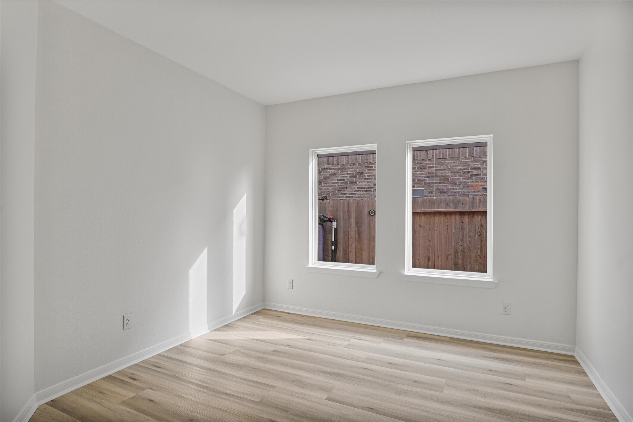 10511 Kings River Drive Rosharon, TX 77583 - Photo 16 of 25 a view of an empty room with wooden floor and a window