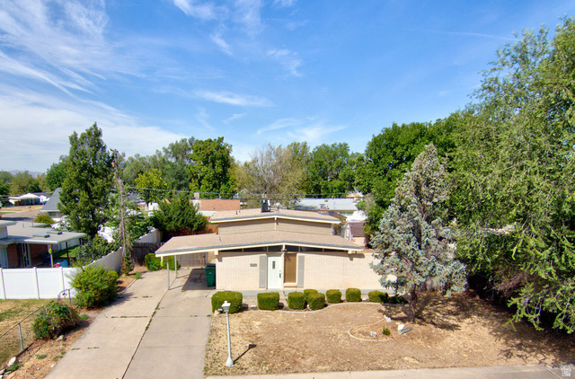 669 Colonial Avenue Layton, UT 84041 - Photo 49 of 51 Mid-century modern residence featuring a light brick exterior and a flat roofline