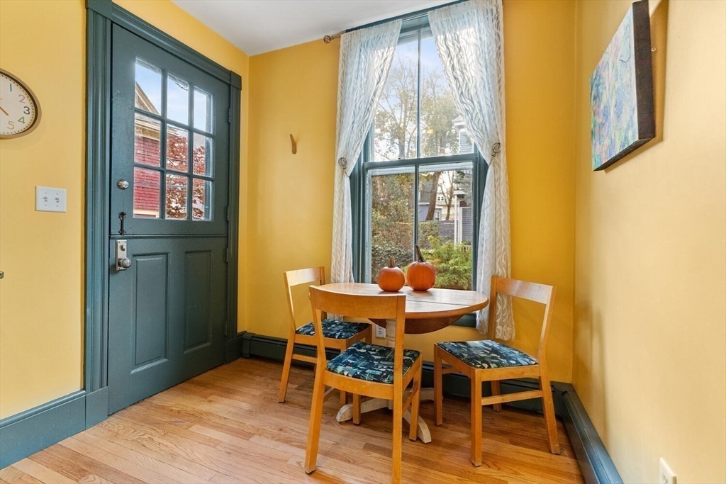 72 Cypress Street, Unit 1 Brookline, MA 02445 - Photo 14 of 23 a dining room with furniture wooden floor and windows