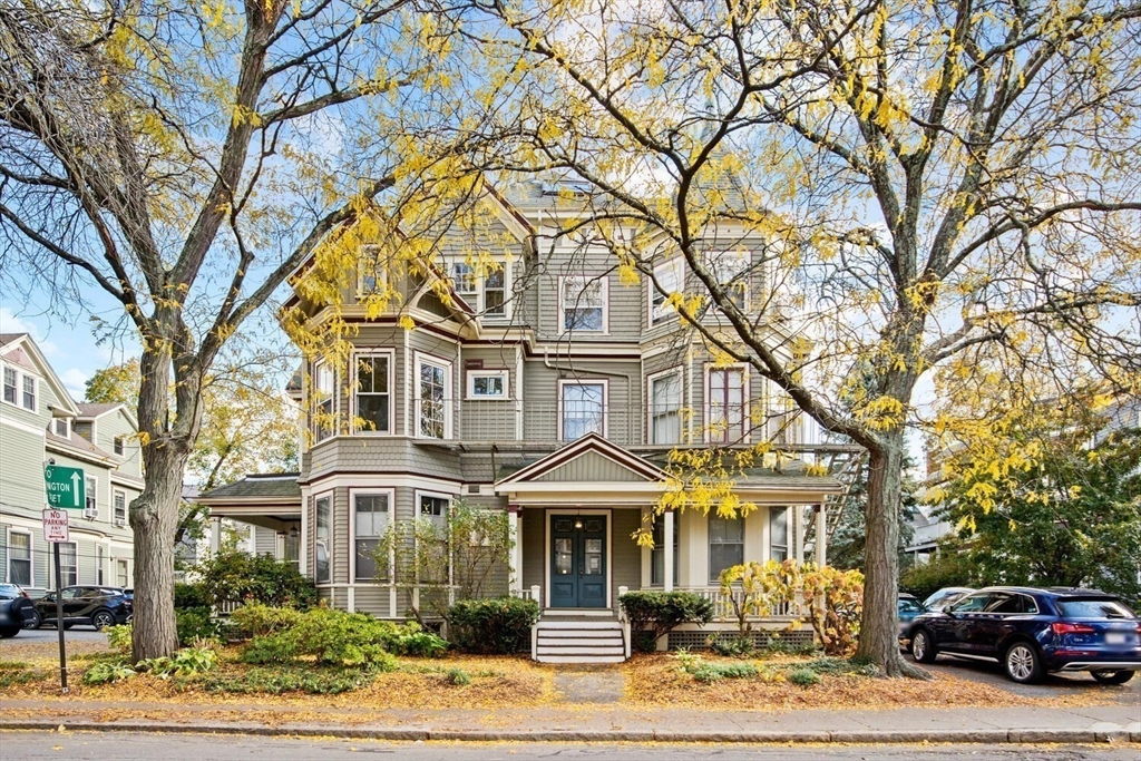 72 Cypress Street, Unit 1 Brookline, MA 02445 - Photo 21 of 23 a front view of a residential apartment building with a yard