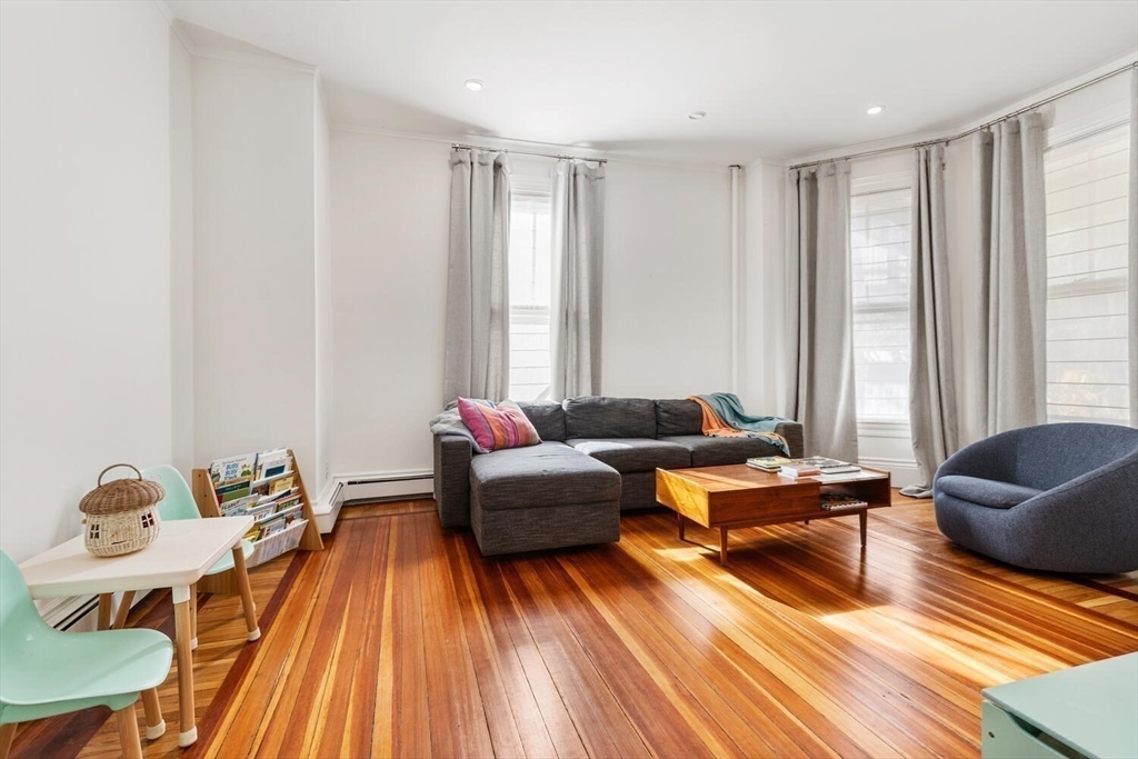 72 Cypress Street, Unit 1 Brookline, MA 02445 - Photo 8 of 23 a living room with furniture and a wooden floor